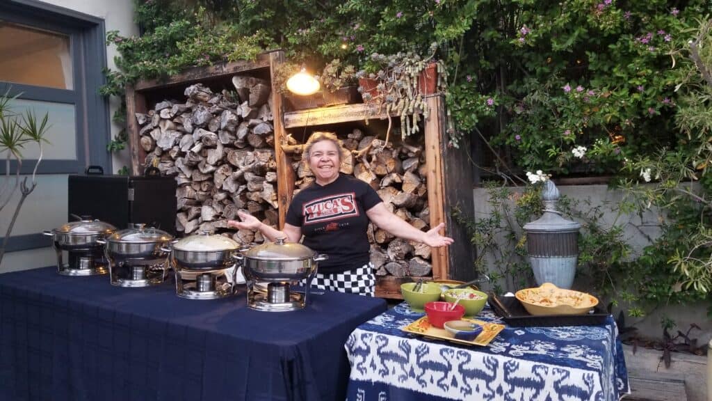 Dora beams behind her catering set up